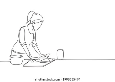 Single one line drawing young woman making cookie dough using rolling pin at kitchen table  Making bakery   homemade pizza at home  Modern continuous line draw design graphic vector illustration
