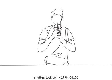 Single one line drawing young handsome male hold plastic cup and drink iced green tea with straw. Make him refreshing in summer season. Modern continuous line draw design graphic vector illustration