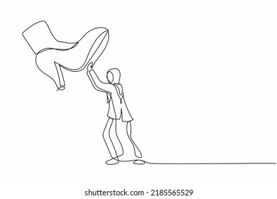 Single one line drawing young Arab businesswoman against giant shoes stomping. Female employee push against giant foot step. Minimal metaphor. Continuous line draw design graphic vector illustration
