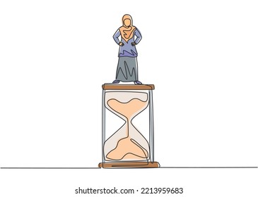 Single one line drawing of young Arabian business woman standing above hourglass. Symbol to show time management business minimalist concept. Continuous line draw design graphic vector illustration.