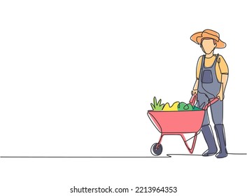 Single one line drawing of young male farmer standing beside the wheelbarrow trolley filled with fruits. Farming challenge minimalist concept. Continuous line draw design graphic vector illustration