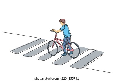 Single one line drawing of a young man riding a bicycle crossing the zebra crossing at a crossroads. Cycling has become a lifestyle for urban people. One line draw design graphic vector illustration.