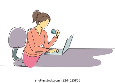 Single one line drawing young woman sitting on chair and typing entering credit card code on laptop around desk. Digital payment concept. Modern continuous line draw design graphic vector illustration