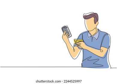 Single one line drawing young man sitting on chair and typing entering credit card code on laptop around desk. Digital payment concept. Modern continuous line draw design graphic vector illustration