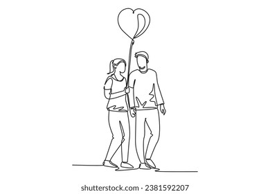 Single one line drawing young happy man and woman couple take a walk at public park together and holding heart shape balloon. Marriage anniversary. Continuous line design graphic vector illustration