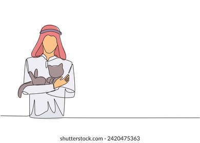 Single one line drawing of young energetic Arabian man holding a cuddle funny cat in front of his chest. The younger generation of animal lovers. Happy man petting cat. Continuous line design graphic