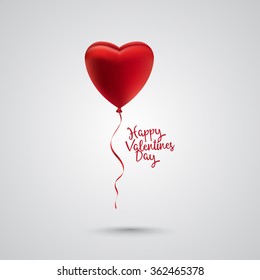 Single red satin balloon hearts on ribbon with happy valentines day text on the side. Gray background and shadow.