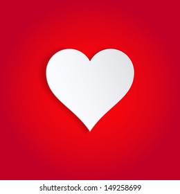 Single white paper heart on red background.