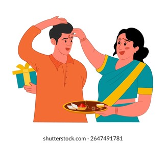 sister applying tilak on forehead to brother on occasion of Raksha bandhan or bhai dooj indian festival	
