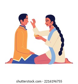 sister giving blessings to the brother by putting tika
