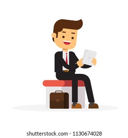 Sitting business man using his tablet