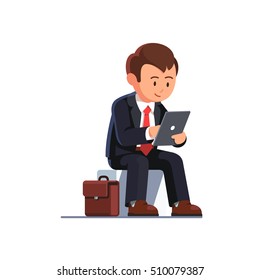 Sitting business man using his tablet computer holding it in left hand and taping screen with right. Flat style vector illustration isolated on white background.