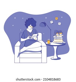 Sitting in a chair, a girl is reading on a tablet, and a cat is sleeping next to her