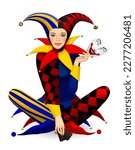 Sitting cross-legged girl dressed in a colorful Joker costume with his mask and playing cards in her hands isolated on white. Three Dimensional stylized drawing. Vector illustration