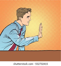 Sitting man stops someone. Man stopping someone. Man rejecting something. Forbidding man. Handsome young businessman giving stop signal. Concept idea of advertisement and promo. Halftone background.