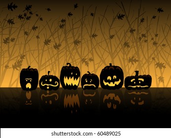 Six jack-o-lanterns sit in the woods on Halloween