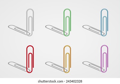 six paperclips with different color on gray background