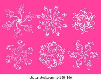 Six pink swirly floral rosettes.