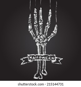 Skeleton hand with chalk on a blackboard, and a banner. Halloween card.