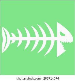 skeleton of white fish isolated on a green background