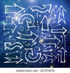 Sketch arrow collection for your design on blurred glowing background. Elements of this image furnished by NASA. 