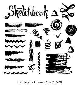 Sketch brushes and decorative grunge elements. Natural smears and strokes for design on the black background.
