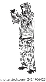 Sketch of young man in hooded jacket taking photo on smartphone, black and white vector hand drawing isolated on white