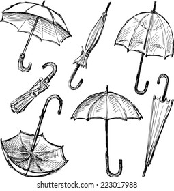 Sketches of opened and closed umbrellas, accessories, hand drawn vector illustration isolated on white