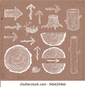 Sketches of wood cuts, logs, stump and wooden arrows on brown craft parcel paper background