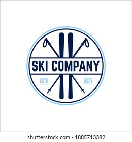 Ski board and sticks in a retro round badge