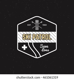 Ski patrol patch. Vintage outdoor design with mountain winter rescue gear. Outdoor adventure logo design. Travel hipster monochrome insignia. Wilderness emblem and stamp. Vector.