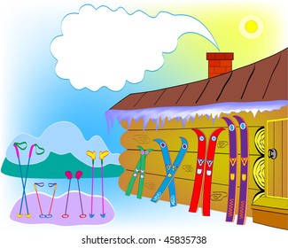 Skis, ski sticks, mittens of an amicable family against the house and mountains