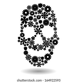 Skull shape made of many black flowers on white, dia de los muertos