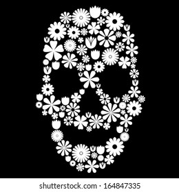 Skull shape made of many white flowers on black, contrast concept