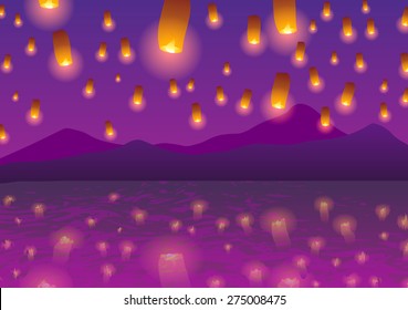 Sky lanterns at sunset over the water.