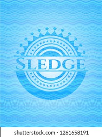 Sledge light blue water wave style badge.