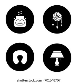Sleeping accessories glyph icons set. Neck pillow, dream catcher, aroma candle, table lamp. Vector white silhouettes illustrations in black circles