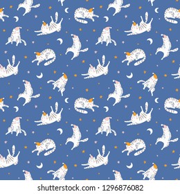 Sleeping cats in the blue night starry  sky. Vector seamless pattern. Hand drawn design for baby  fabric design.