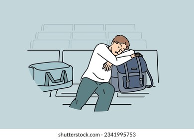 Sleeping man sits in lounge area at airport and waits for arrival of plane delayed due to bad weather. Tired guy airport passenger with bags and luggage waiting for flight and travel