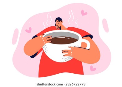 Sleepy man with cup of coffee inhales aroma of invigorating beverage, wanting to drink large portion of espresso. Guy drinks coffee to get rid of drowsiness and gain strength before working day