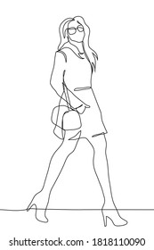 slender young woman in a short coat, sunglasses and high heels walks holding her hand with a bag in her pocket. A beautiful woman with long flowing hair walks with a wide stride looking at the observe
