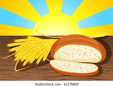 Sliced loaf of bread and wheat ears