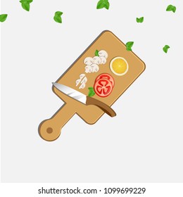 Sliced mushrooms, tomato and lemon on a chopping board with knife. 