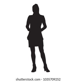 Slim young lady standing with hands in pockets. Isolated vector silhouette