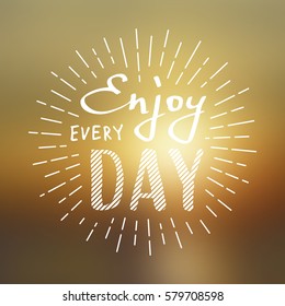 Slogan Enjoy every day. Vector illustration on blurred background. Lettering for greeting card