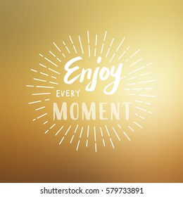 Slogan Enjoy every moment. Vector illustration on blurred background.