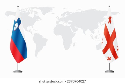 Slovenia and Georgia flags for official meeting against background of world map.