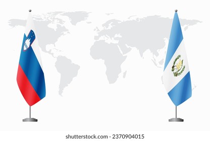 Slovenia and Guatemala flags for official meeting against background of world map.