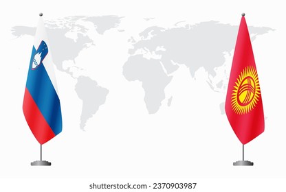 Slovenia and Kyrgyzstan flags for official meeting against background of world map.