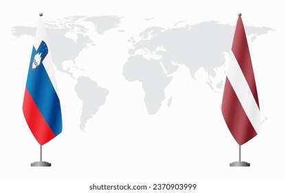 Slovenia and Latvia flags for official meeting against background of world map.